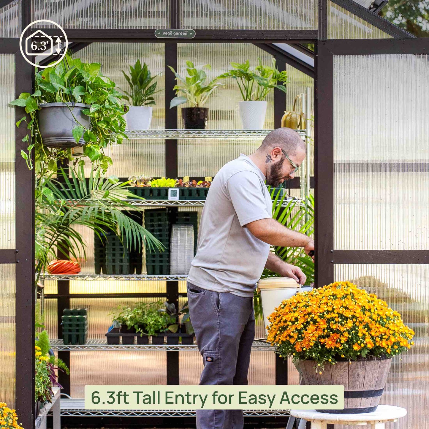 8.5 ft wide greenhouse with arched roof and double doors set in a backyard garden