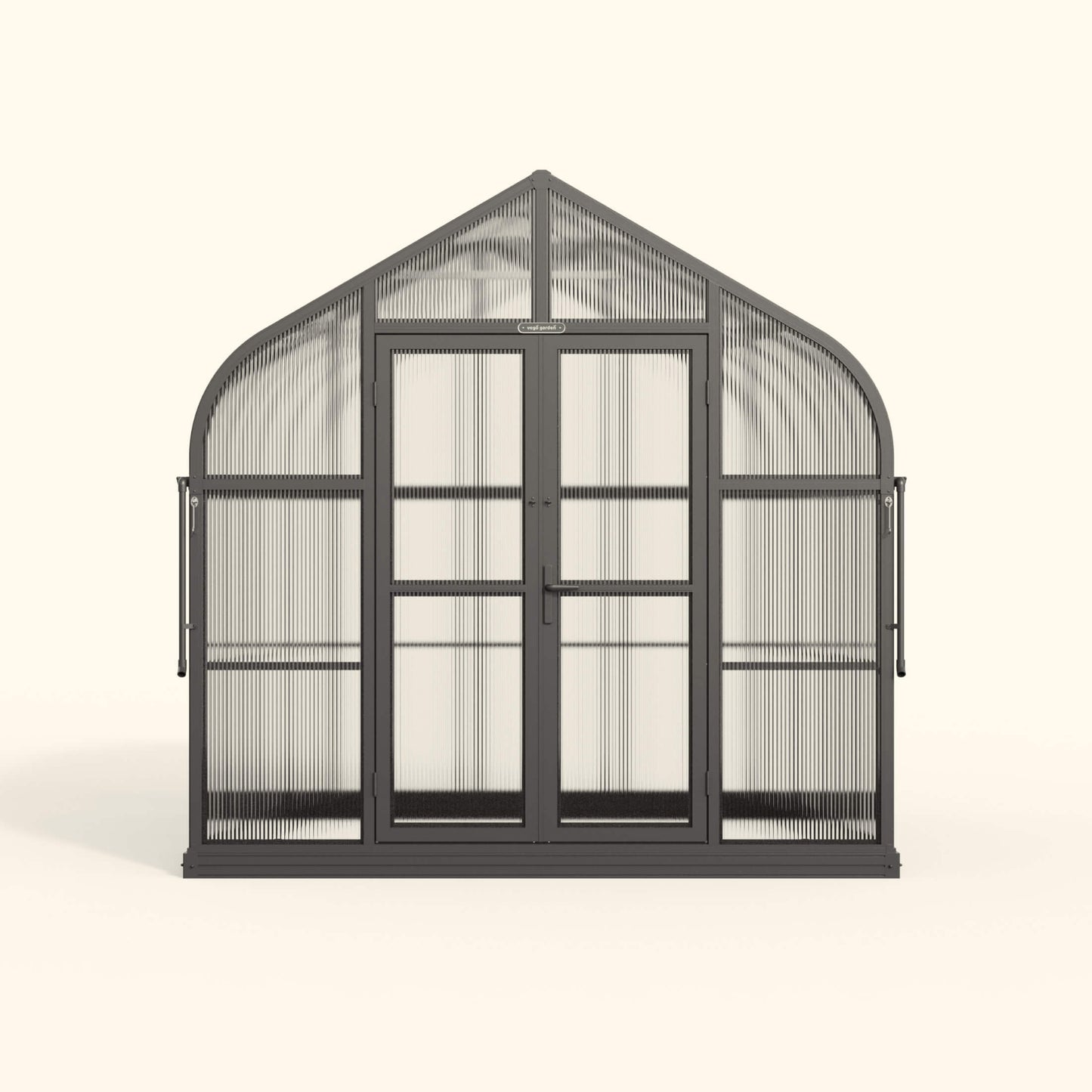 Exterior view of an 8.5 ft wide Pacific-style greenhouse with clear panels and a peaked roof in a backyard garden
