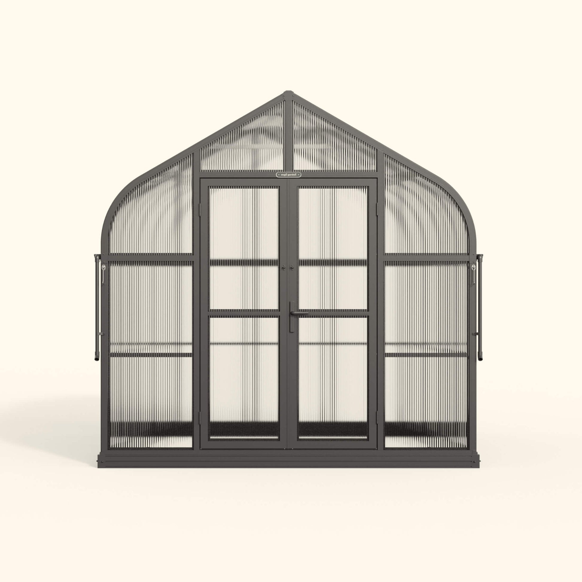 Exterior view of an 8.5 ft wide Pacific-style greenhouse with clear panels and a peaked roof in a backyard garden