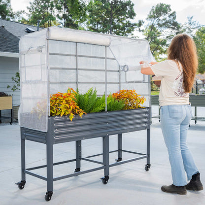 Green fabric frost cover stretched over an elevated garden bed with attached trellis panels for climbing plants.
