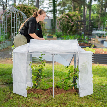Slim mesh cover with reinforced edges and zipper opening protecting plants while allowing airflow