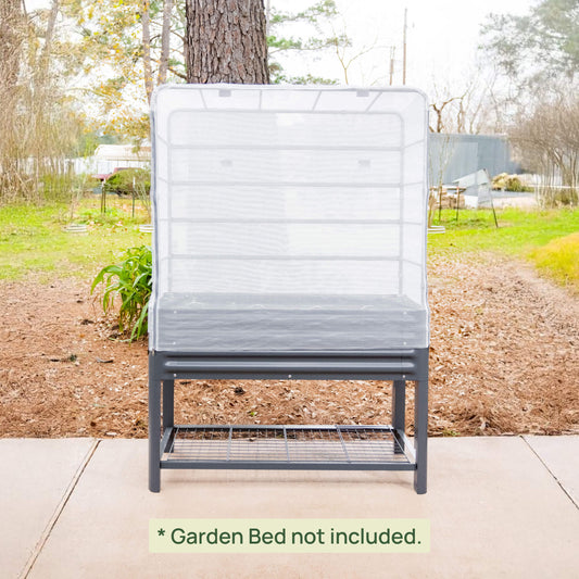 Raised garden bed with mesh cover system over vegetables and climbing trellis protecting plants from pests