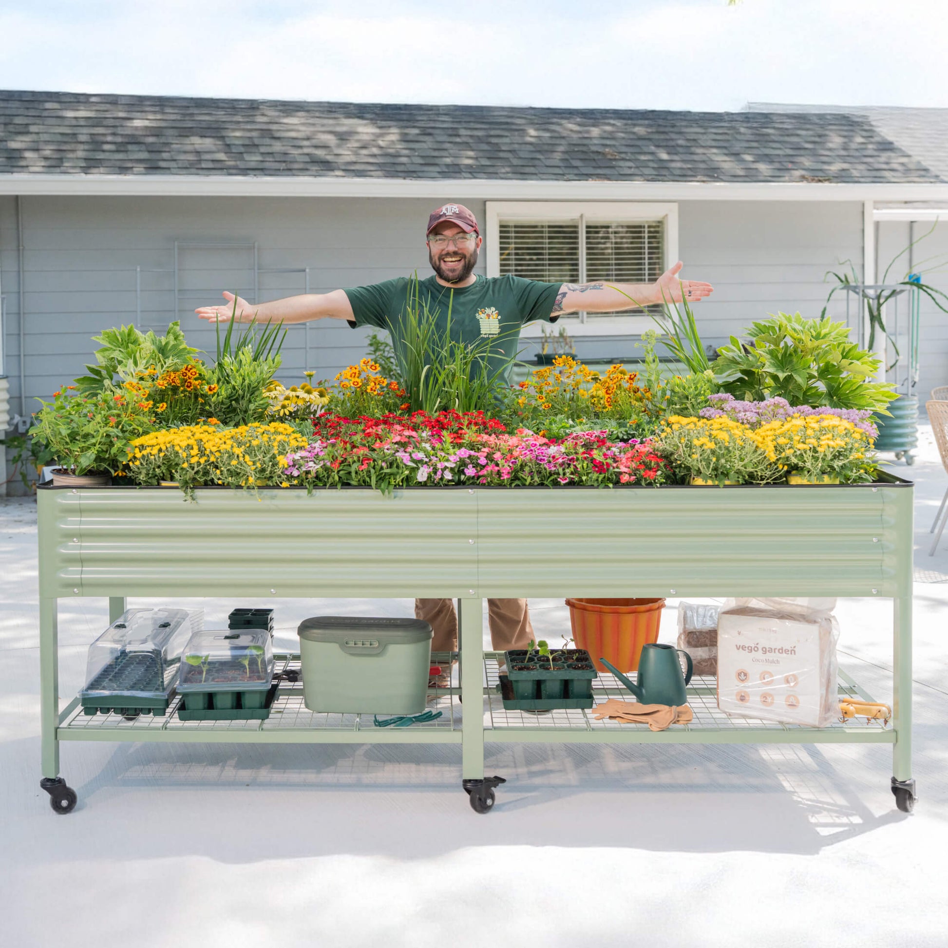 Raised wooden garden bed 3x8 ft on legs filled with vegetables and herbs in backyard setting