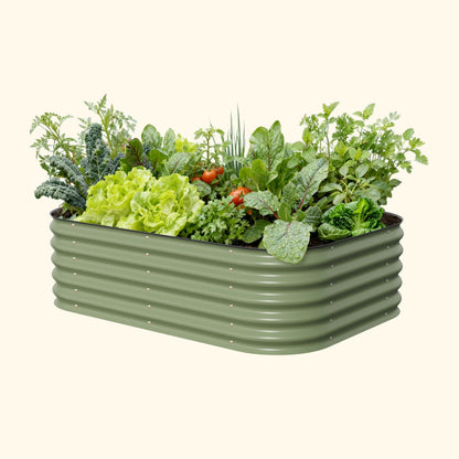 Six-panel 17-inch tall modular metal raised garden bed assembled on mulch with leafy vegetables growing