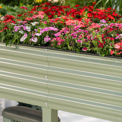 Large elevated wooden garden bed with soil and young vegetable seedlings in a backyard