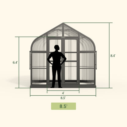 Large Pacific-style greenhouse with pitched roof and clear panels set on a wooden deck surrounded by potted plants