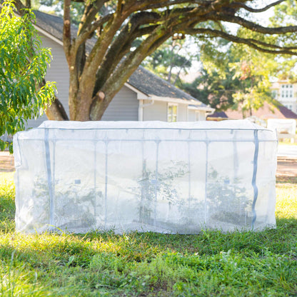 Frost protection garden cover with integrated trellis draped over tomato plants in raised bed