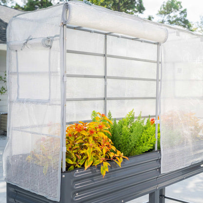 Green frost cover and trellis system attached to an elevated garden bed protecting climbing plants