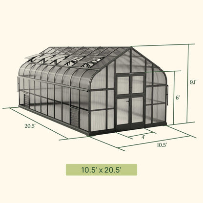 Large Pacific greenhouse with clear panels and a peaked roof set on a backyard patio, showing side vents and double door
