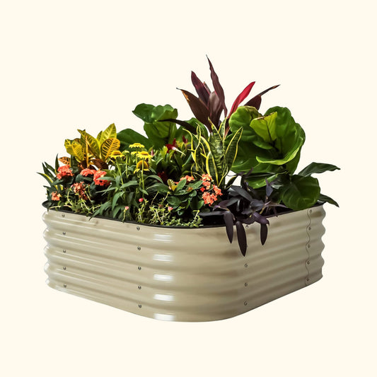 14-inch tall modular metal raised garden bed kit assembled with soil and young vegetable seedlings in a backyard