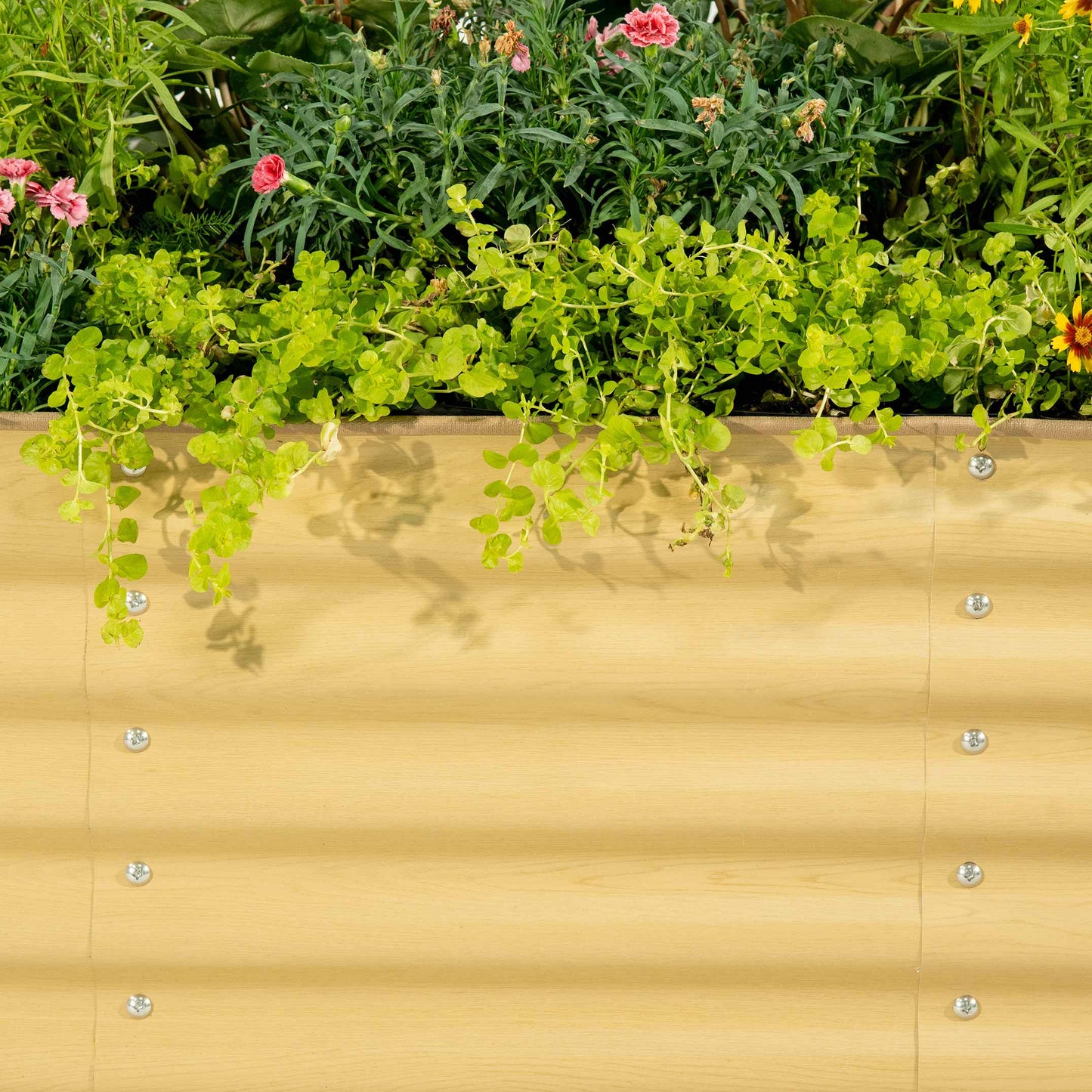 Six-panel modular metal raised garden bed standing 17 inches tall in a backyard with vegetables and flowers