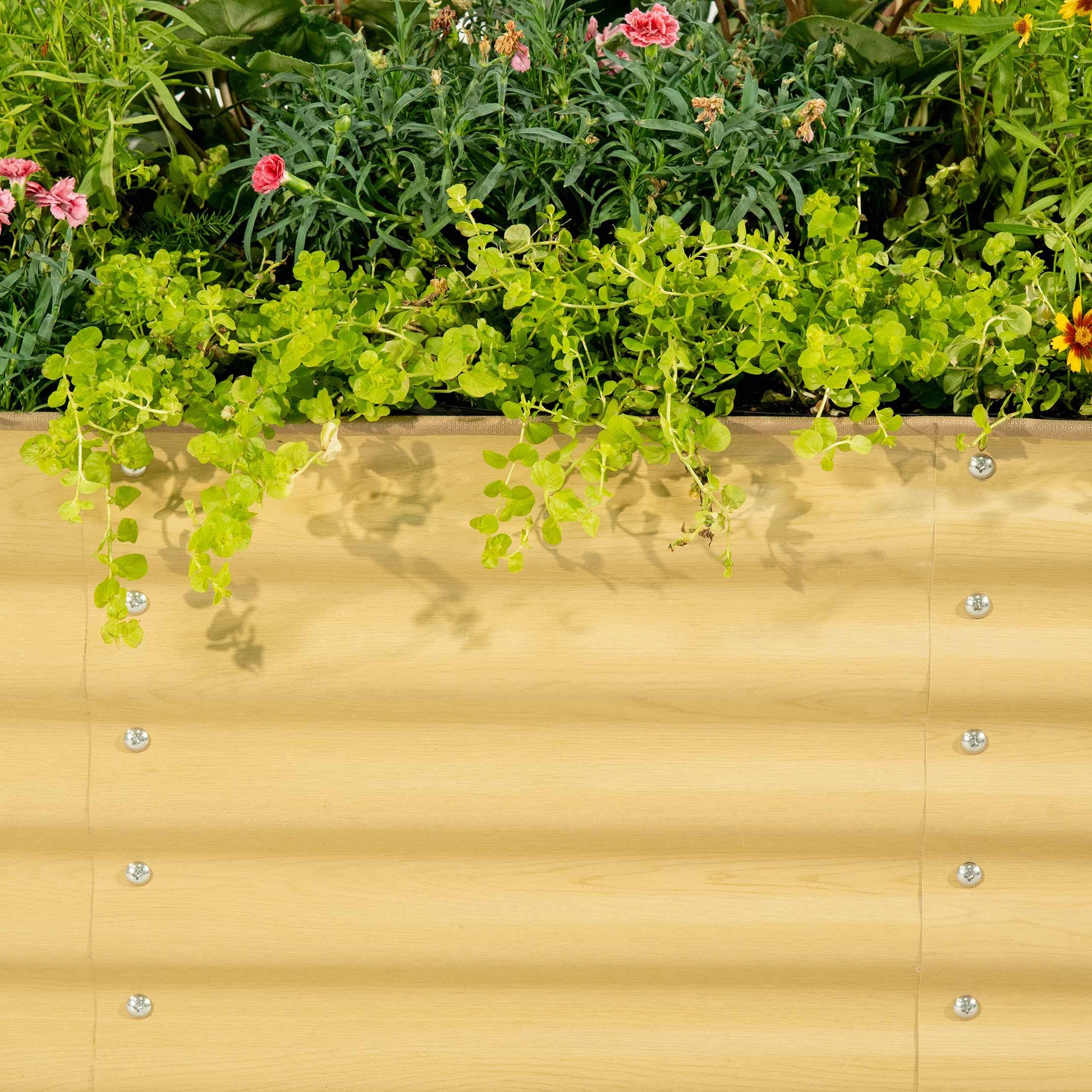 Six-panel modular metal raised garden bed standing 17 inches tall in a backyard with vegetables and flowers